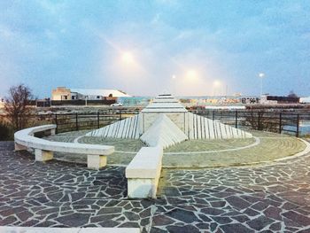 Built structure in winter against sky during sunset