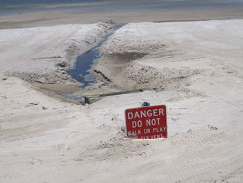 High angle view of text on sand at beach