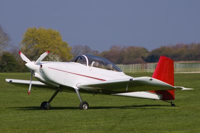 Airplane on runway against sky