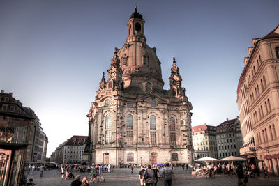 People at cathedral against clear sky