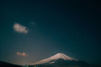 Low angle view of mountain against sky at night