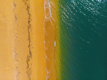 Aerial view of sunny golden beach with turquoise water top view