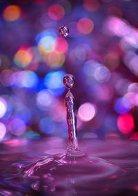 Close-up of drop falling on water