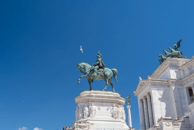 Low angle view of statue against clear blue sky