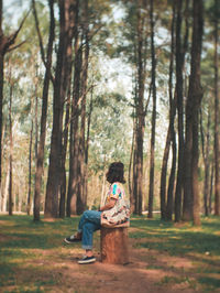 Rear view of woman sitting in park