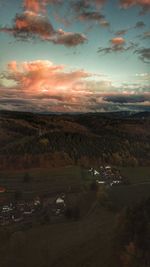 Scenic view of field against sky at sunset