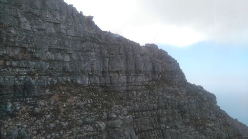 Low angle view of tree mountain against sky