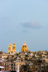 Cathedral in city against sky