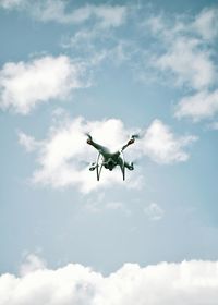 Low angle view of airplane flying against sky