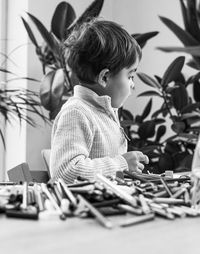 High angle view of boys and color crayons 