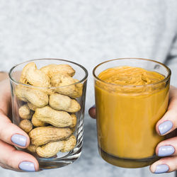 Midsection of woman holding food in jars