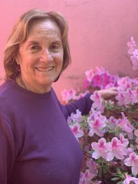 Portrait of smiling woman with pink flower