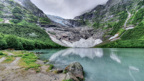 Scenic view of lake and mountains against sky