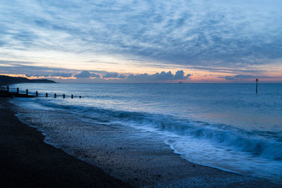 Scenic view of beach against sky during sunset