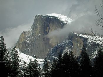 Low angle view of snowcapped mountains against sky