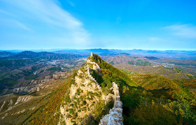 Scenic view of mountain against cloudy sky