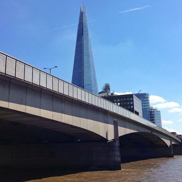 architecture, built structure, building exterior, city, skyscraper, modern, tall - high, tower, low angle view, sky, office building, capital cities, travel destinations, famous place, blue, reflection, international landmark, connection, travel, water