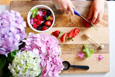 High angle view of person chopping strawberry