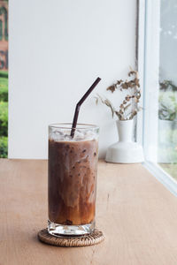 Close-up of coffee and glass on table