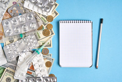 High angle view of pen on table against blue background