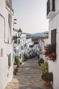 Narrow street amidst buildings against sky