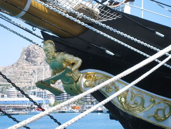 Low angle view of sculpture on ship in river during sunny day