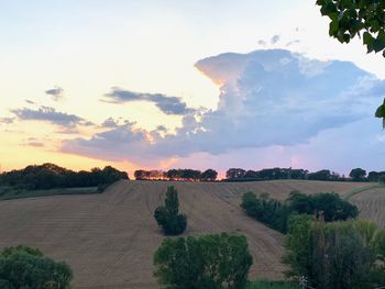 Scenic view of land against sky during sunset