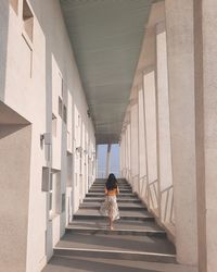 Rear view of woman walking in corridor