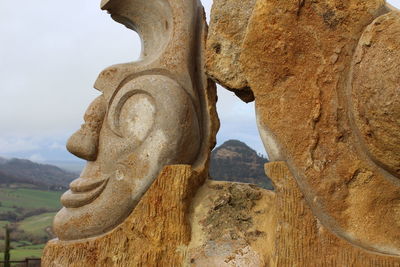 Close-up of rock formation against sky