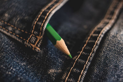 Close-up of pencil on denim