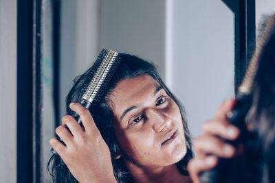 Portrait of young woman looking at camera