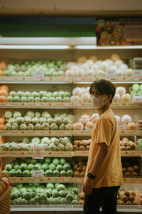 Rear view of man standing at store