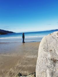 Scenic view of beach against blue sky