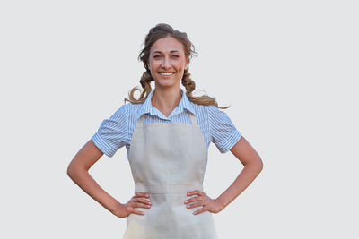 Portrait of a smiling young woman against white background