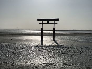 Lifeguard hut on beach against sky