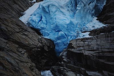 Low angle view of glacier on rock formation