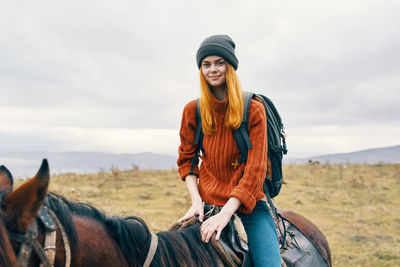 Smiling young man with a horse