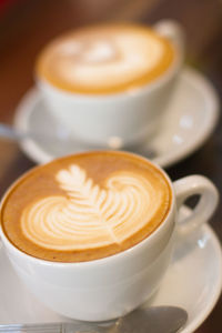 Close-up of two cups of cappuccino