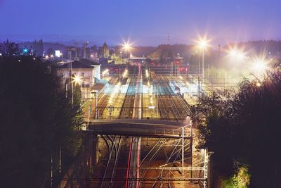 High angle view of railroad tracks against sky at night