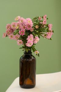 Close-up of pink flower vase on table