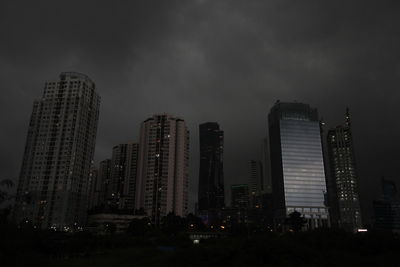 Illuminated city against sky at night