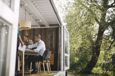 Business colleagues working in portable office truck