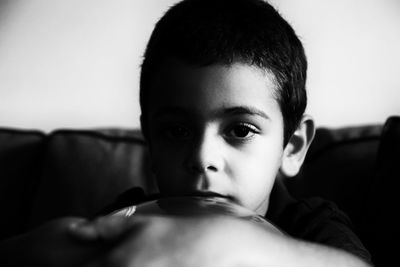 Close-up portrait of shirtless boy at home