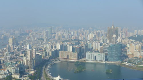 Aerial view of buildings in city against sky