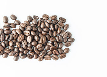 High angle view of coffee beans against white background