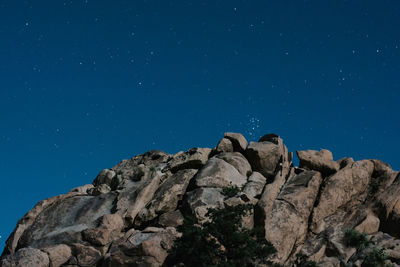 Low angle view of rock formation against blue sky