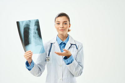 Mid adult woman standing in front of white background