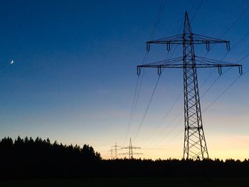 Low angle view of electricity pylon against sky