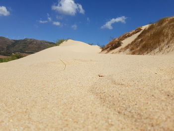 Scenic view of mountain against blue sky