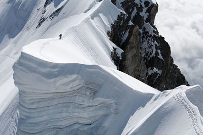 Scenic view of people on snow covered aiguille de rochefort